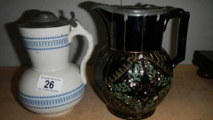 A Victorian mourning jug with pewter lid and one other.