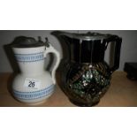 A Victorian mourning jug with pewter lid and one other.