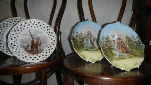 A pair of 19th century hand painted plates and a pair of ribbon plates.