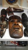 5 carved wood wall masks.