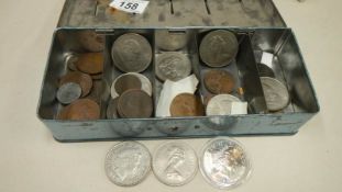 A tin of assorted coins including 2 £5 coins.