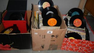 2 boxes and a case of 45 rpm vinyl records.