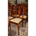 A set of 4 high backed chairs.