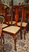 A set of 4 high backed chairs.