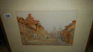 A framed & glazed watercolour of a village