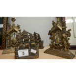 A pair of brass ship book ends and a pair of brass bear with beehive ornaments.