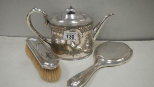 A silver backed hand mirror and hair brush together with a silver plated tea pot.