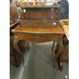 A Victorian mahogany writing desk with ormolu brass banding and writing surface in drawer.