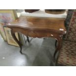 A Victorian mahogany fold over card table.