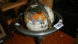 A jewelled desk top globe.