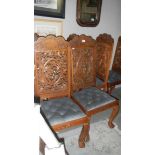 A set of 8 ornately carved chairs.