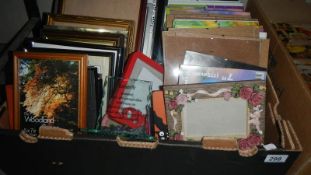 A box of assorted photo frames.