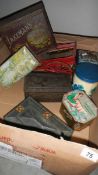 A box containing collector's tin boxes, lion ornament, cart and pipes.