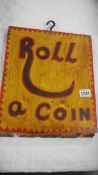 A 'Roll a coin' wooden sign.