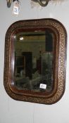 An antique framed bevel edged mirror.