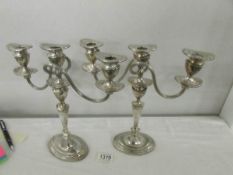 A pair of silver plate candelabra.