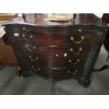 A Georgian serpentine fronted veneered chest of drawers.