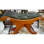 A teak stool with buttoned seat.