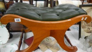 A teak stool with buttoned seat.