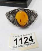 A silver and amber bracelet.