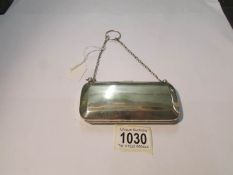 A silver purse with chain strap, hall marked for Birmingham but date letter indistinct,.