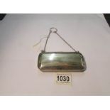 A silver purse with chain strap, hall marked for Birmingham but date letter indistinct,.