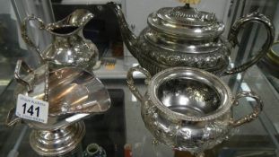 A 3 piece silver plated tea set and a sugar scuttle.