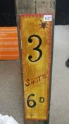 An old wooden '3 Shots 6d' sign.