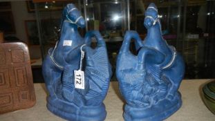 A pair of blue horse figures,.