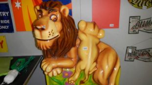 A Falgas fibre glass perched lion with cub.