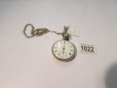 A silver pocket watch on a yellow metal chain (crack to dial).