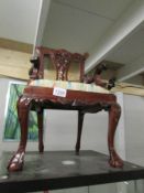 A replica mahogany child's elbow chair.