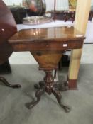 A Victorian work/sewing table with marquetry walnut veneered top.