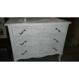 A white painted 3 drawer chest.