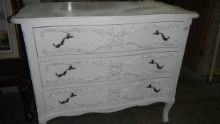 A white painted 3 drawer chest.