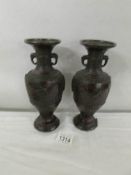 A pair of Japanese bronzed vases.