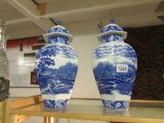 A pair of Adam's blue and white cattle scenery lidded vases, a/f.