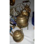 3 brass kettles, a floral decorated kettle and 3 brass trivets.