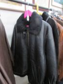 A Carlo Santini black leather jacket with zip fastening and fur collar,