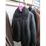 A Carlo Santini black leather jacket with zip fastening and fur collar,