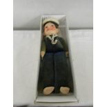 A boxed sailor doll.