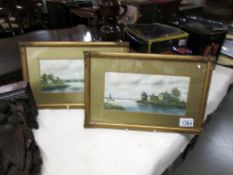 A pair of framed and glazed rural scene watercolours signed Russell.