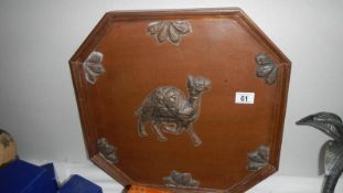 A wooden tray depicting a camel.