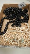 3 black bead necklaces, 2 pearl necklaces and one other a/f necklace.