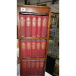 A small bookcase containing a full set of Dicken's novels.