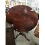 A Victorian mahogany tripod tip top table.