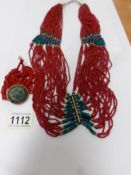 A coral tribal necklace.