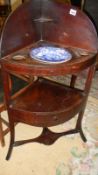 A mahogany corner washstand with blue and white basin.