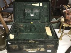 A 1905 gentleman's travel case with brushes, button hook,