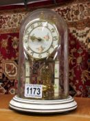 A Kundo German anniversary clock with glass dome,